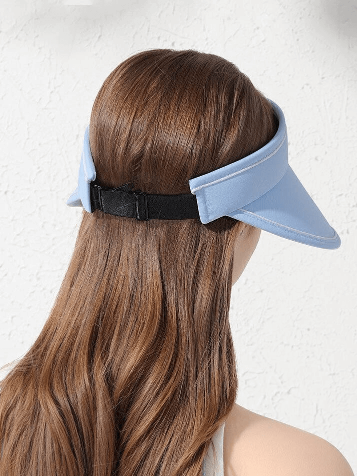 Woman wearing blue adjustable sun-proof hollow visor cap with foldable design, ideal for sun protection and travel-friendly convenience.